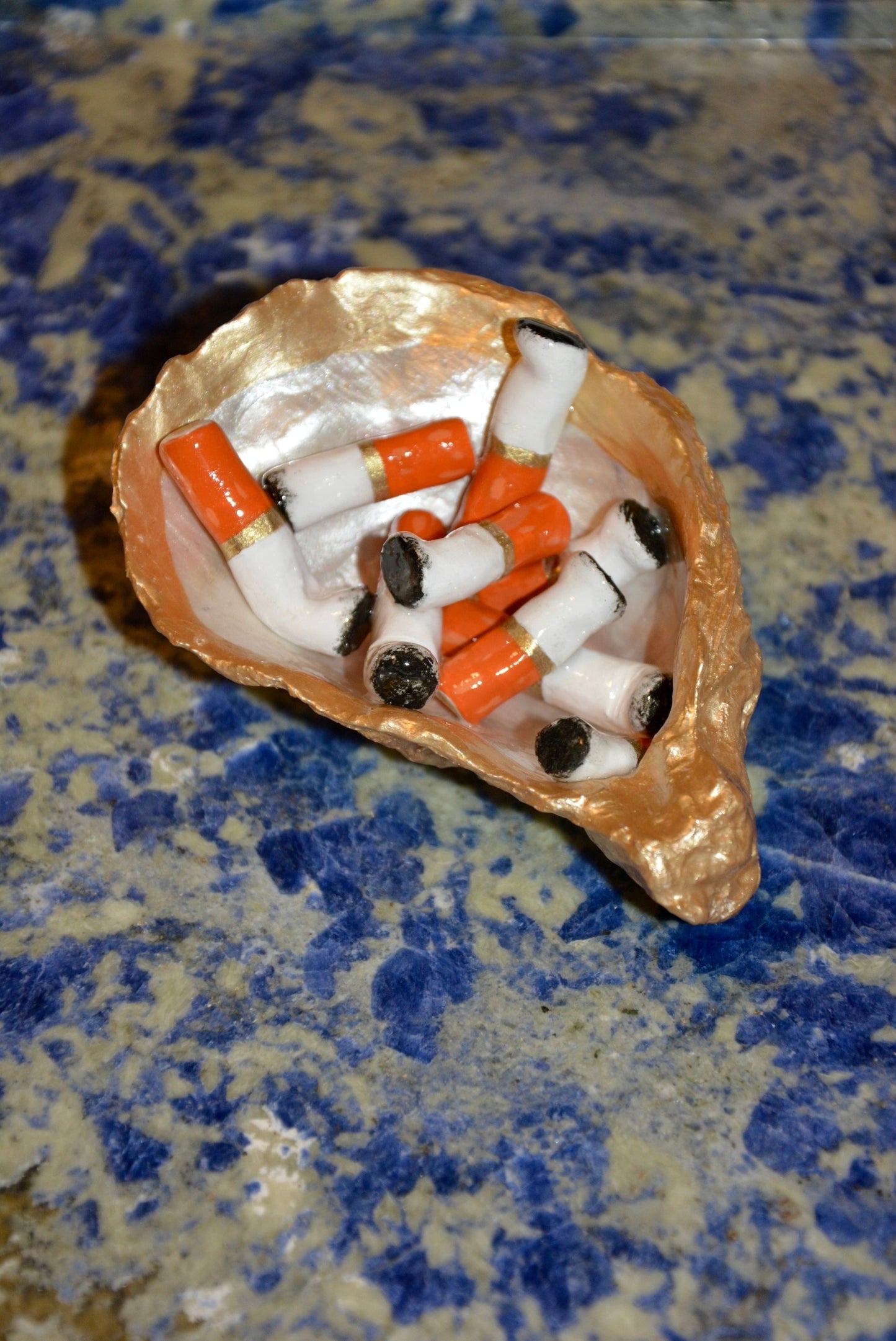 OYSTER SHELL CIGARETTE SCULPTURE